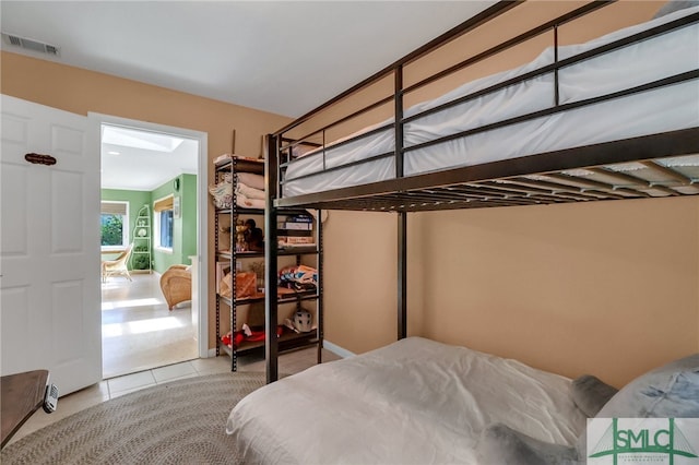 tiled bedroom with connected bathroom