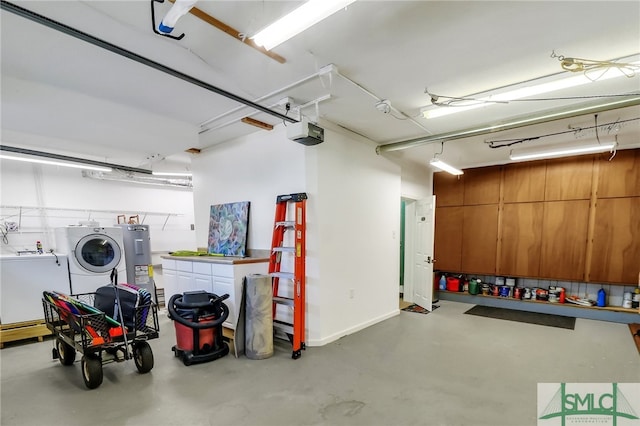 garage with washing machine and dryer and a garage door opener