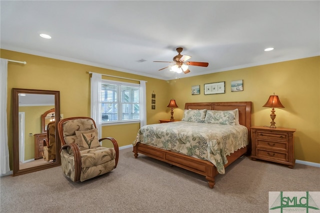 carpeted bedroom with ceiling fan and crown molding