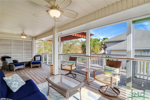 sunroom featuring a healthy amount of sunlight, ceiling fan, and wood ceiling