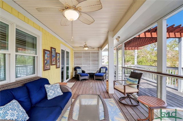 sunroom / solarium featuring ceiling fan