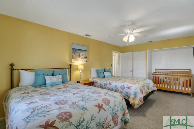 carpeted bedroom with ceiling fan and a closet