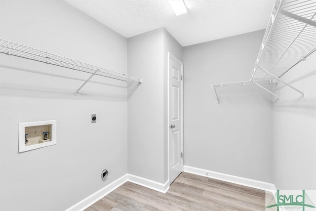 laundry area featuring washer hookup, electric dryer hookup, and hardwood / wood-style floors