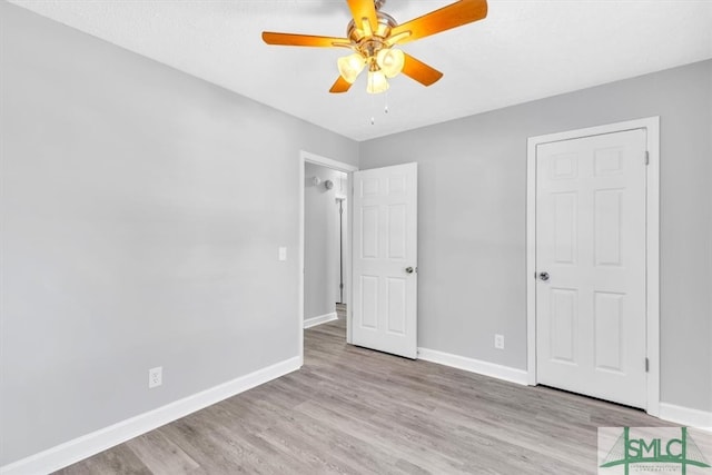 unfurnished bedroom with ceiling fan and light wood-type flooring