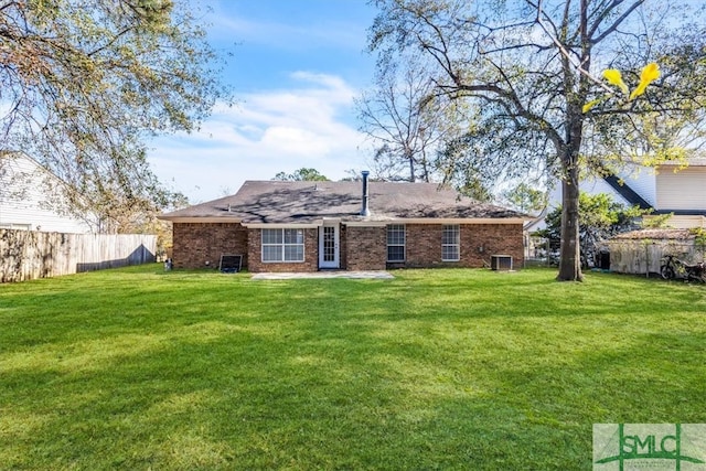 rear view of property featuring a yard