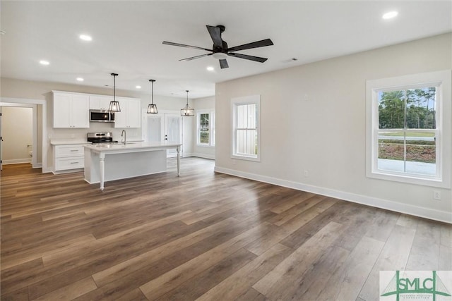 215 Wildwood Dr, Sylvania, GA 30467 - unfurnished living room featuring plenty of natural light, dark wood-style floors, recessed lighting, and ceiling fan