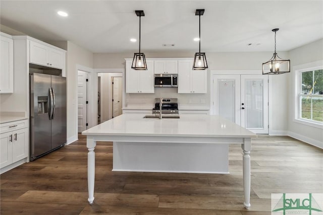 215 Wildwood Dr, Sylvania, GA 30467 - kitchen featuring stainless steel appliances, light countertops, recessed lighting, dark wood-style flooring, and white cabinets
