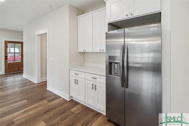 215 Wildwood Dr, Sylvania, GA 30467 - kitchen with stainless steel fridge with ice dispenser, dark wood-style floors, light countertops, and white cabinets