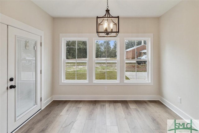 215 Wildwood Dr, Sylvania, GA 30467 - unfurnished dining area with a chandelier and wood finished floors