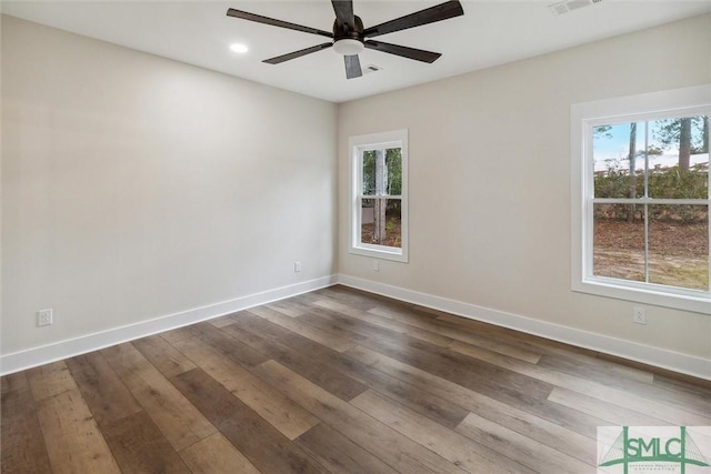 215 Wildwood Dr, Sylvania, GA 30467 - spare room featuring healthy amount of natural light, a ceiling fan, dark wood-style floors, and recessed lighting