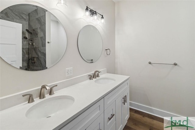 215 Wildwood Dr, Sylvania, GA 30467 - full bathroom featuring double vanity, wood finished floors, and tiled shower