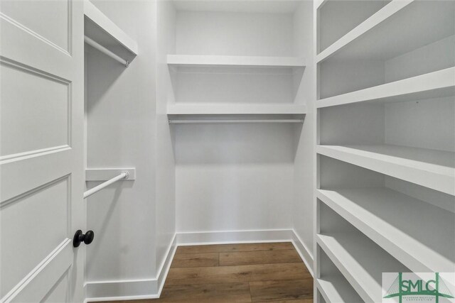 215 Wildwood Dr, Sylvania, GA 30467 - walk in closet with dark wood-type flooring
