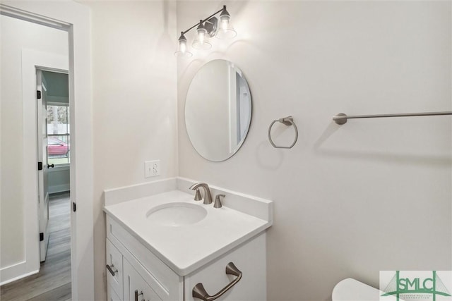 215 Wildwood Dr, Sylvania, GA 30467 - half bathroom featuring vanity and wood finished floors