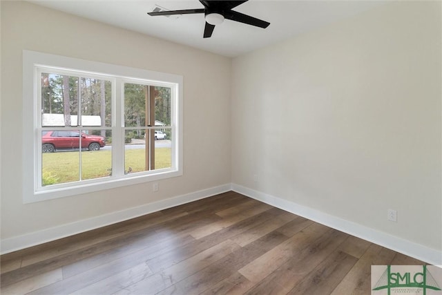 215 Wildwood Dr, Sylvania, GA 30467 - empty room featuring dark wood-style flooring and ceiling fan