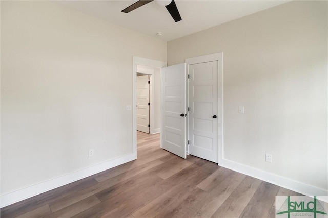 215 Wildwood Dr, Sylvania, GA 30467 - unfurnished bedroom with wood finished floors and a ceiling fan