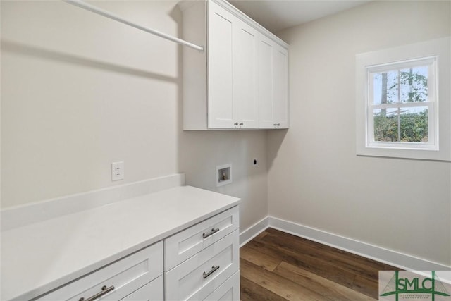 215 Wildwood Dr, Sylvania, GA 30467 - laundry room featuring cabinet space, dark wood-type flooring, hookup for a washing machine, and electric dryer hookup
