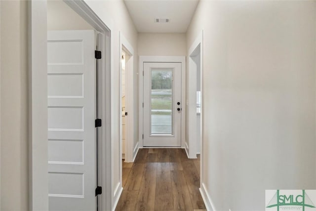 215 Wildwood Dr, Sylvania, GA 30467 - doorway to outside with baseboards and wood finished floors