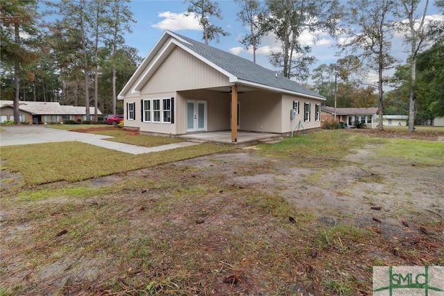 215 Wildwood Dr, Sylvania, GA 30467 - rear view of property with french doors and a yard