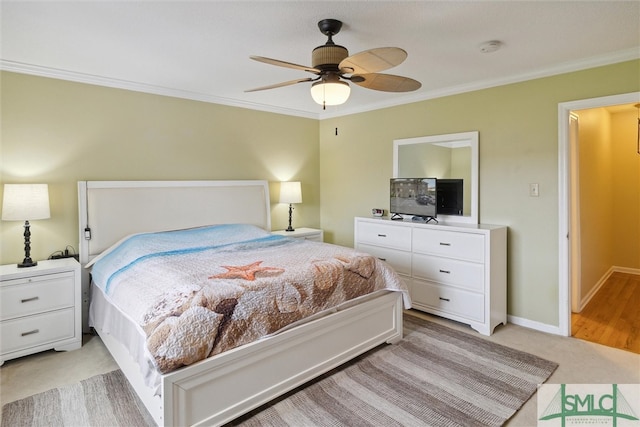 carpeted bedroom with ornamental molding and ceiling fan