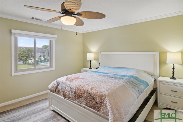 carpeted bedroom featuring ornamental molding and ceiling fan