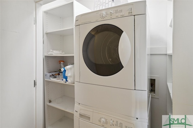 laundry room with stacked washer / drying machine