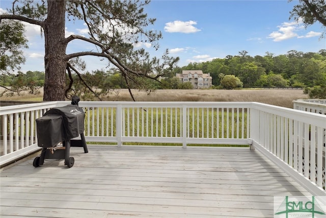 wooden deck with a grill