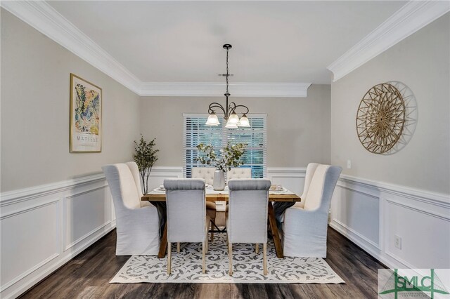 dining room featuring ornamental molding, dark wood-type flooring, and an inviting chandelier