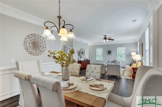 dining room featuring ornamental molding, dark hardwood / wood-style floors, and ceiling fan with notable chandelier