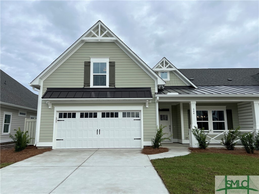 view of front facade with a front lawn, a porch, and a garage