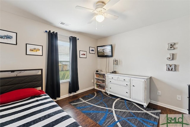 bedroom with ceiling fan and dark hardwood / wood-style floors