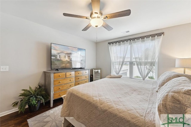 bedroom with ceiling fan and dark wood-type flooring