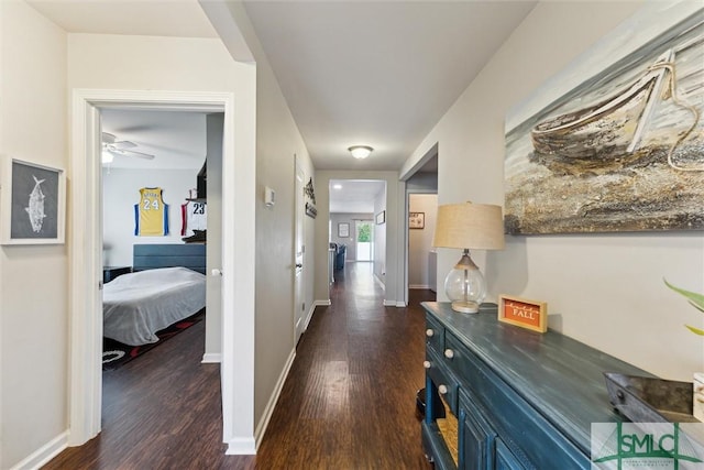 corridor with dark hardwood / wood-style flooring