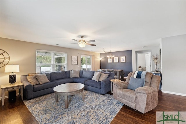 living room featuring dark hardwood / wood-style flooring and ceiling fan with notable chandelier