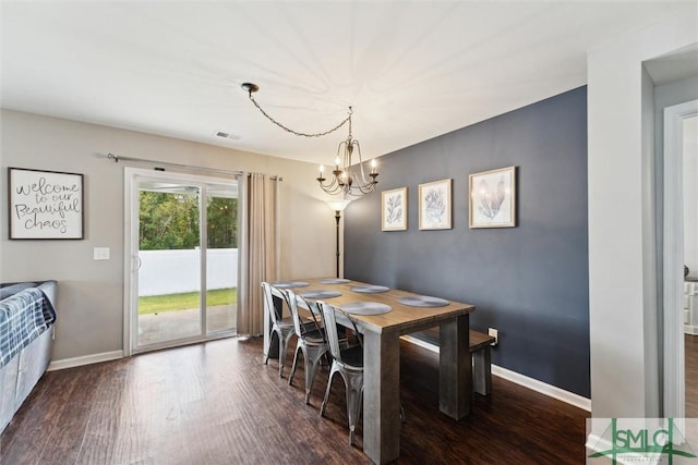 dining area featuring a chandelier and dark hardwood / wood-style flooring