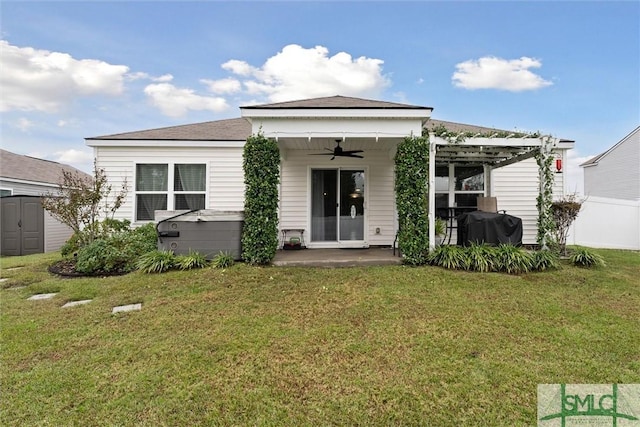 rear view of property with ceiling fan, a yard, a patio, and a pergola