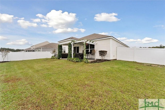 rear view of property with a lawn