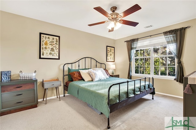 bedroom with ceiling fan and light colored carpet