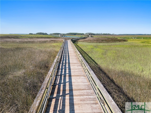 view of dock with a rural view