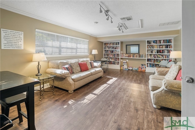 living room featuring wood-type flooring, a textured ceiling, rail lighting, and ornamental molding