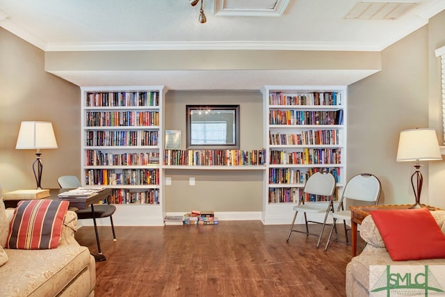 living area with wood-type flooring, a textured ceiling, and ornamental molding