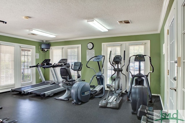 exercise room with a healthy amount of sunlight, a textured ceiling, french doors, and ornamental molding