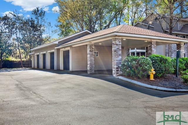 view of front of property with a garage and a carport