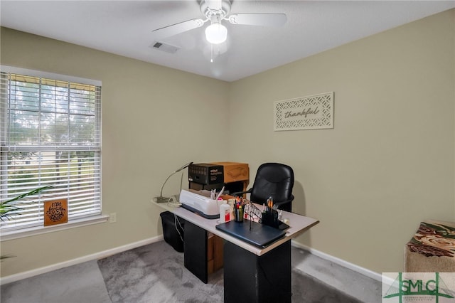 carpeted office space featuring ceiling fan