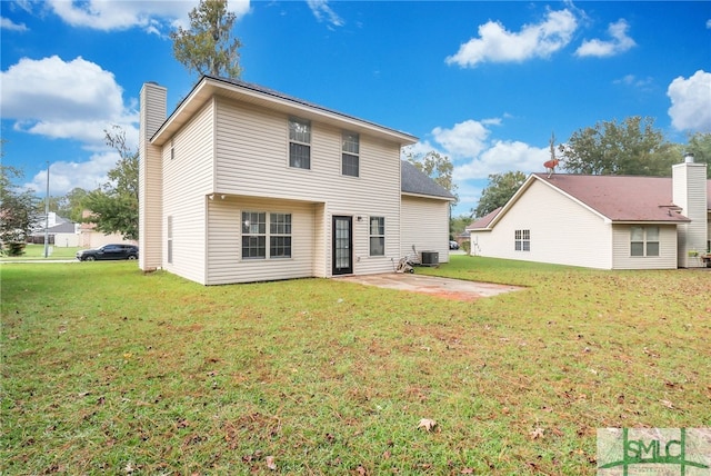 back of property with cooling unit, a yard, and a patio area