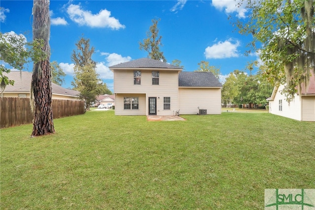 rear view of property with cooling unit, a lawn, and a patio area