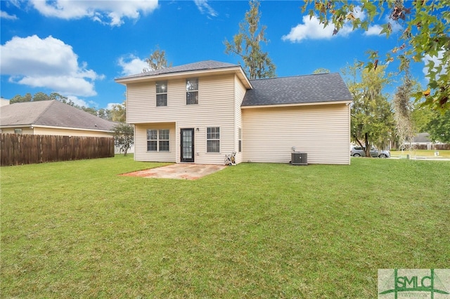 back of house featuring central AC unit, a lawn, and a patio