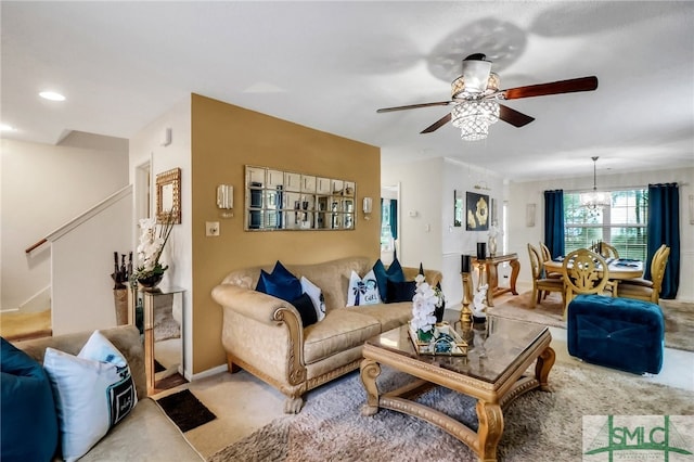 living room featuring light carpet and ceiling fan with notable chandelier