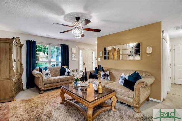 living room featuring a textured ceiling, light carpet, and ceiling fan