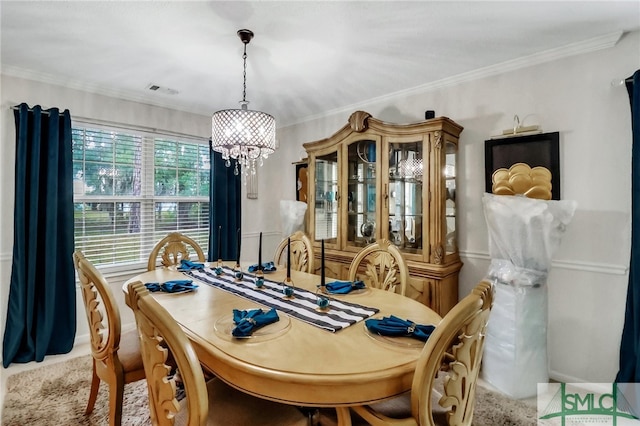 dining room featuring ornamental molding and a chandelier