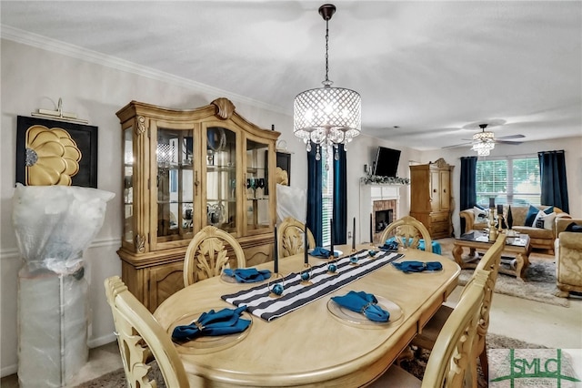 dining space with light carpet, ceiling fan, and crown molding